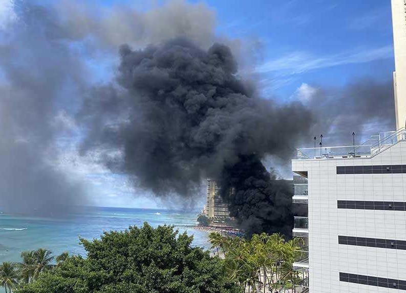 a building with black smoke coming out of it