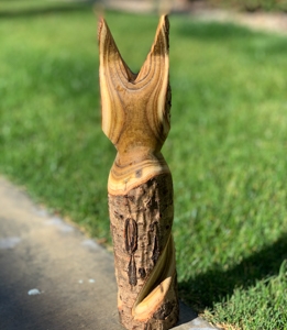 a wood carving of a cat